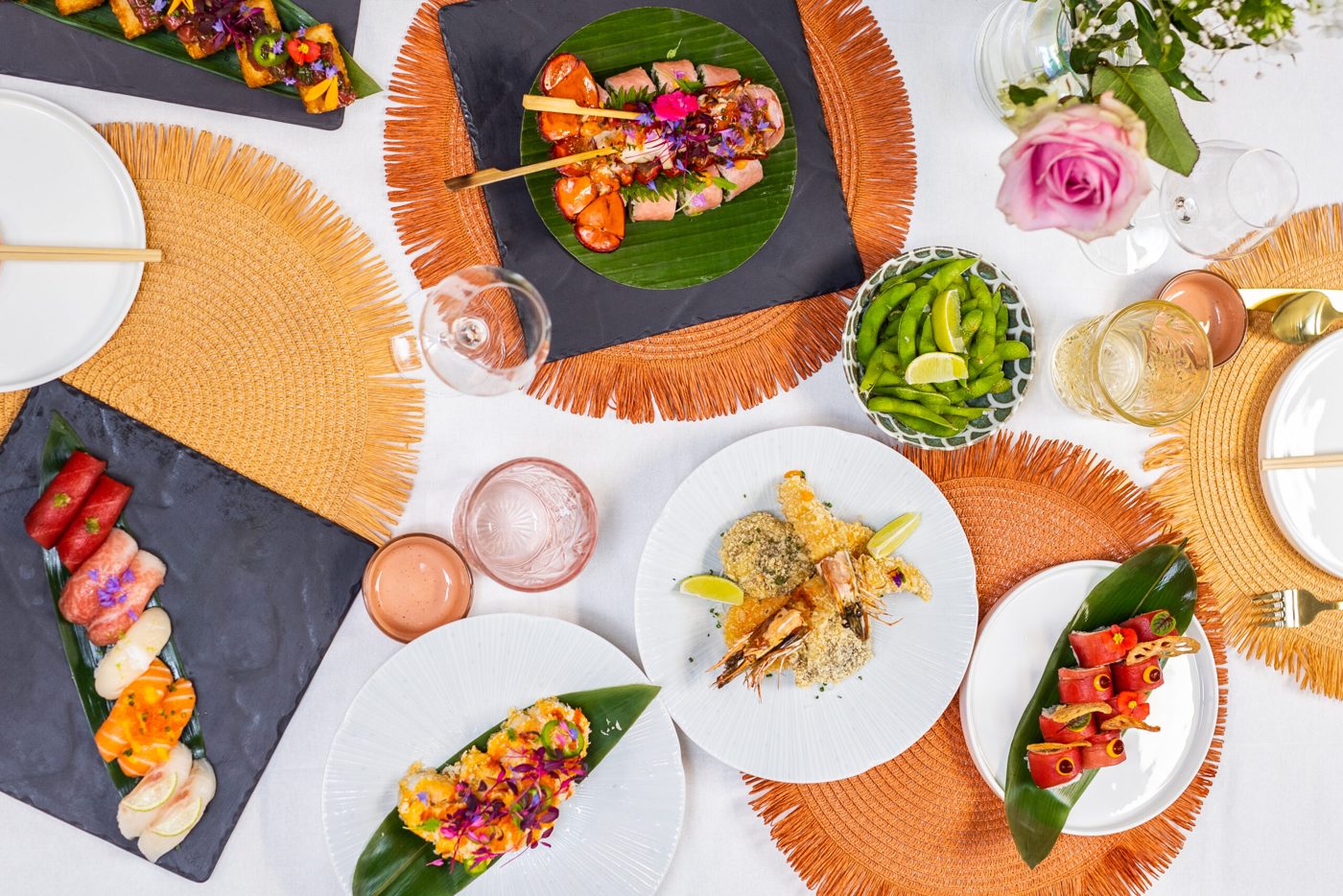 Social Roots photo of a set table with fresh dishes, edamame and edible flowers