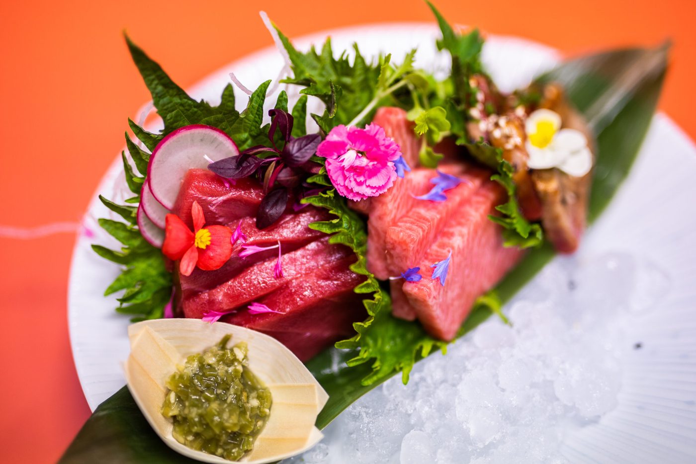 Social Roots food photo of sashimi with fresh herbs and edible flowers